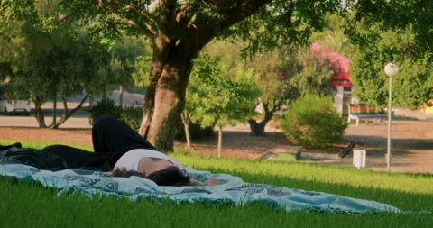 Woman sleeping in a park Stock Footage 341773572