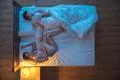 The woman sleeping in a pose near the man. evening night time. view from abov Photo