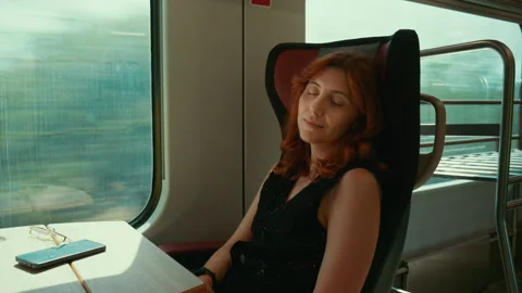 Woman sleeps seated on the train while commuting to work Stock Footage 340271901