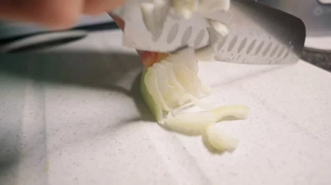Woman slice an onion at the kitchen Stock Footage 63779161