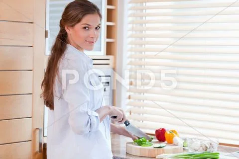 Woman slicing a pepper Stock Photos
