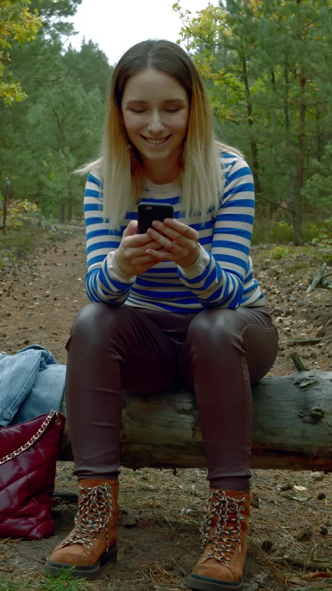 Woman with smartphone in the forest. Stock Footage 280768853