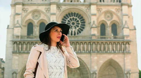 Woman with smartphone in front of Notre Dame Stock Footage