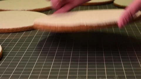 Woman smears paste on white cork table Vídeo Stock 127261453