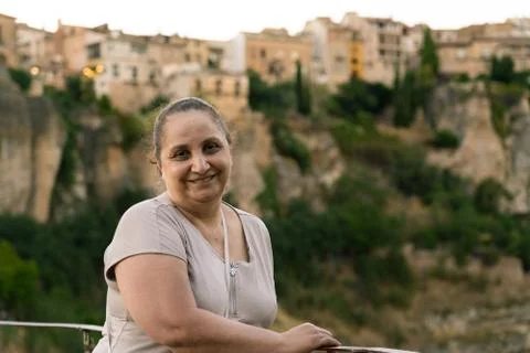 Woman smiling to camera In Cuenca with casas colgantes in the background Stock Photos