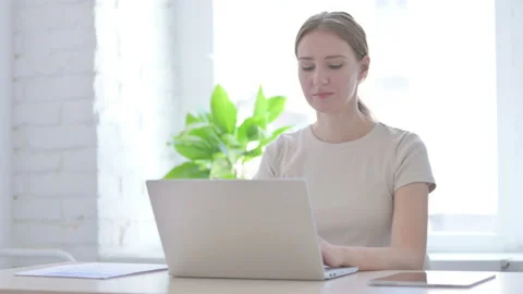 Woman Smiling at Camera while using Laptop Stock Footage 205000050