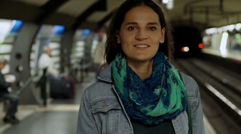 Woman smiling to the camera while waiting for metro, steadycam shot Stock Footage 44006806