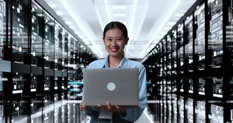 Woman Smiling To Camera While Working On A Laptop In Server Room Database Stock Footage 248004966