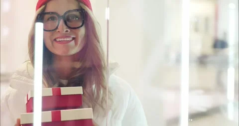 Woman Smiling with Gift Boxes Inside Shopping Mall Stock Footage 323237449