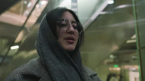 Woman Smiling Inside Elevator in Warm Outfit Vídeos de archivo 310147528