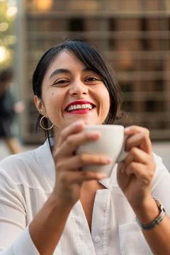 Woman smiling looking at camera with a coffee cup Stock Photos