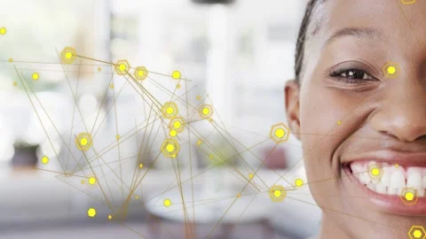 Woman smiling while animated yellow hex nodes starting over teeth, showing IT Stock Footage 333063153