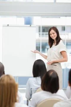 Woman smiling while giving a presentation Fotos Stock