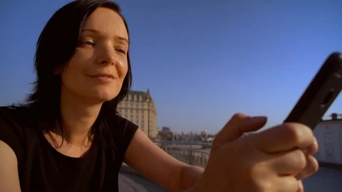 Woman is smiling while reading message on her cellular phone Stock Footage 92861327