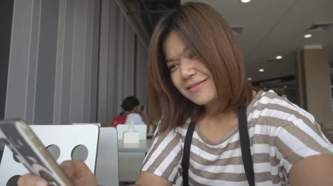 Woman smiling while using phone in social community Stockbeeldmateriaal 65832357