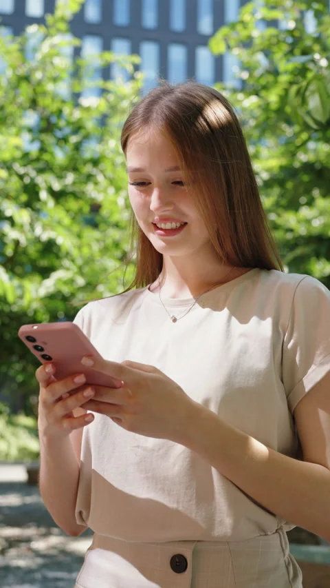 Woman Smiling While Using Smartphone Outdoors Stock Footage 278671362