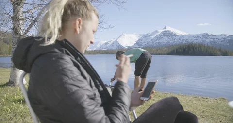 Woman smoking a cigarette while using mobile phone Stock Footage 85963678