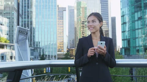 Woman sms texting using app on smart phone in city business district Stock-Footage 68547741