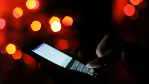 Woman sms texting using app on smartphone at night in city. Close-up. Video stock 101038166