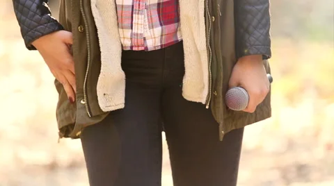 Woman snapping her fingers and holding a microphone Stock Footage 59556539