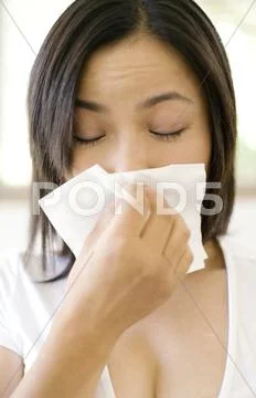 Woman sneezing Stock Photos