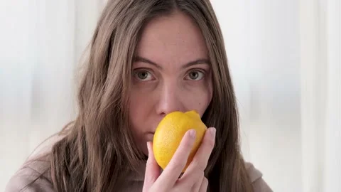 Woman sniffs lemon and does not smell Video stock 143579492
