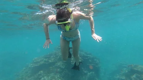 A Woman snorkelling while on vacation in Samoa Stock Footage 131790746