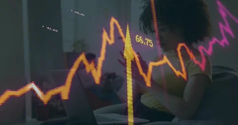Woman on sofa typing on laptop causing finance visuals overlaying jagged line Stock Footage 330380058