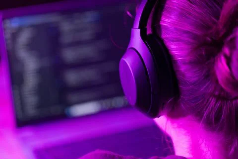 Woman software developer in neon lights Stock Photos