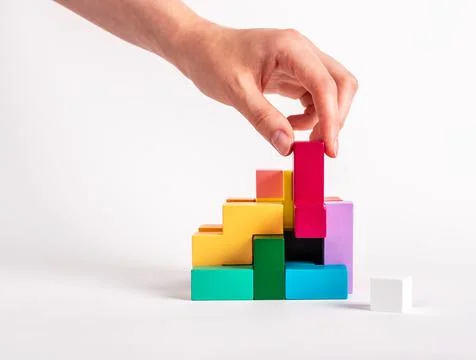 Woman solving logical puzzle. Construction, assembly concept. Analytical Stock Photos