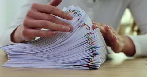 Woman sorting paper documents with paper clips closeup Stock Footage 256413604