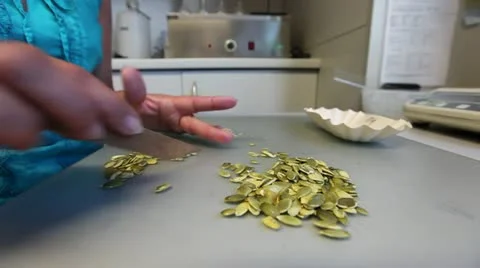 Woman sorting pumpkin seeds Stock Footage 20522819