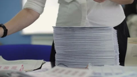 Woman sorting a stack of documents Stock Footage 301409379
