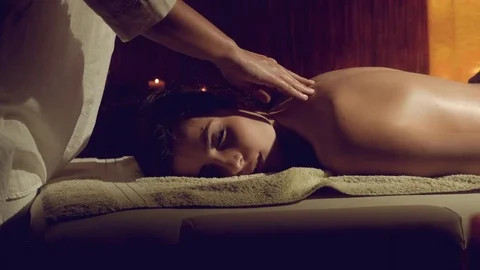 Woman in spa getting back massage retro style dolly shot Stock Footage 71073178