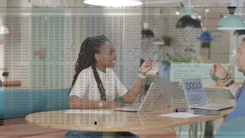 Woman speaking, gesturing at table, tech discussion causing code overlay Stock Footage 329959704