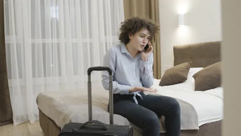 Woman speaking on phone about problems with journey, canceled visa, missed trip Stock Footage 157156060