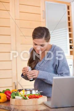 Woman spicing her meal Stock Photos