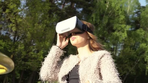 Woman spin round and having fun with virtual reality 3d glasses Stock Footage 78483470