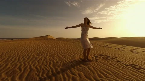 Woman spinning on sand dune Stock Footage