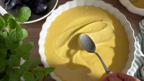 Woman spreading cake batter in baking dish Stock Footage 344974515