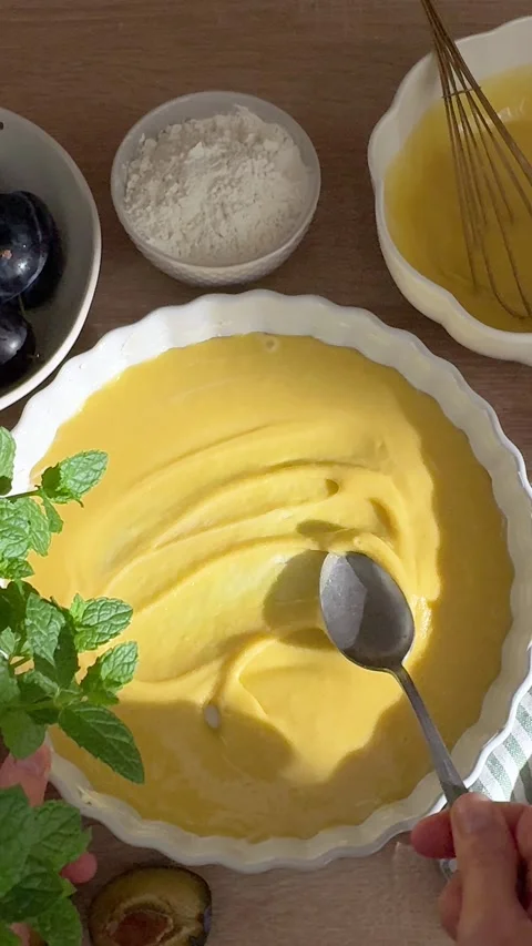 Woman spreading cake batter in baking dish Stock Footage 345026509