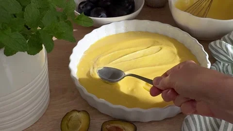 Woman spreading cake batter in baking dish Stock Footage 345110922