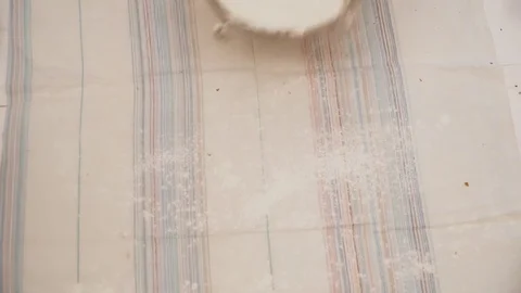 Woman spreading flour through the table Stock Footage