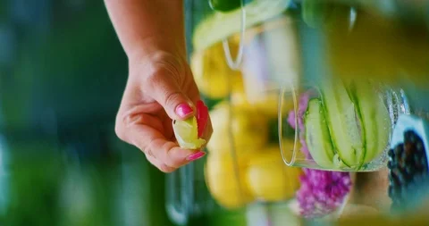 A woman squeezes a slice of lime Stock Footage 113943313
