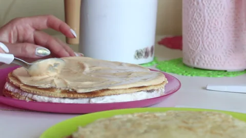 The woman is stacking the cake layers one on top of the other. Lubricates the Stock Footage 156443746