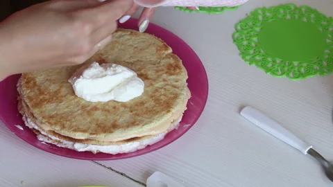 The woman is stacking the cake layers one on top of the other. Lubricates the Stock Footage 156443846