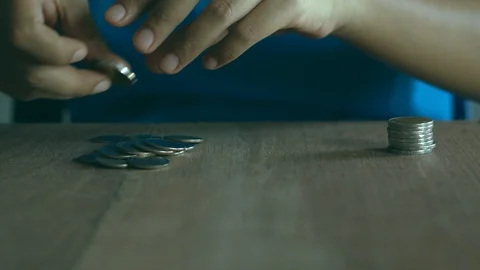 Woman stacking coins on table. Stock Footage 91784072