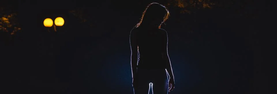 The woman stand on the dark alley. night time Stock Photos