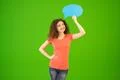 The woman stand with a dialog sign on the green background Photo