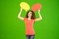 The woman stand with a dialog signs on the green background Photo